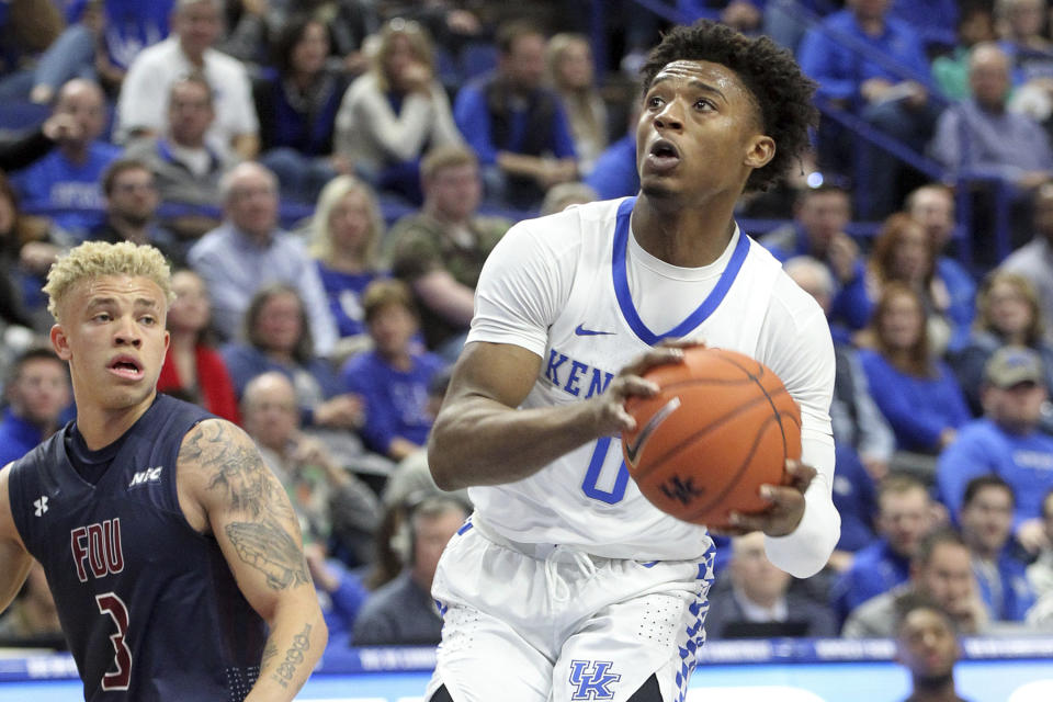 Kentucky's Ashton Hagans, right, looks for an opening near Fairleigh Dickinson's Jahlil Jenkins (3) during the first half of an NCAA college basketball game in Lexington, Ky., Saturday, Dec. 7, 2019. (AP Photo/James Crisp)