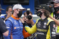 Scott Dixon, of New Zealand, talks with Colton Herta after Dixon won the pole for the Indianapolis 500 auto race at Indianapolis Motor Speedway, Sunday, May 23, 2021, in Indianapolis. (AP Photo/Darron Cummings)