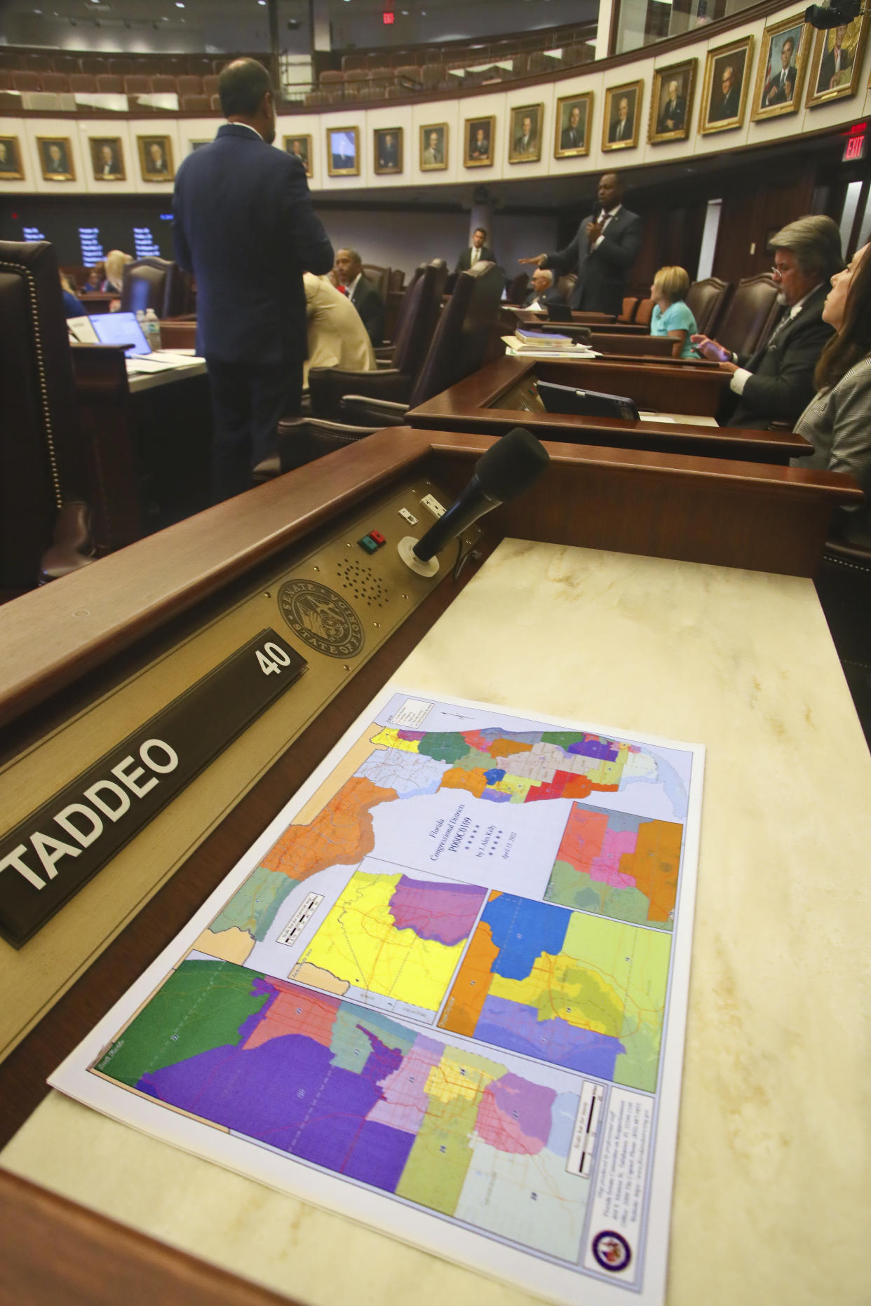 A redistricting map sits on the desk of Sen. Annette Taddeo, D-Miami as debate on amendments to Senate Bill 2-C: Establishing the Congressional Districts of the State goes on during an evening meeting of the Senate Tuesday, April 19, 2022 at the Capitol in Tallahassee, Fla. Taddeo chose to boycott the special session. The Florida special session to address new district lines continues Wednesday. (AP Photo/Phil Sears)