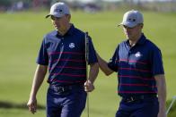 Team USA's Justin Thomas pats Team USA's Jordan Spieth on the back after putting during a foursome match the Ryder Cup at the Whistling Straits Golf Course Friday, Sept. 24, 2021, in Sheboygan, Wis. (AP Photo/Ashley Landis)