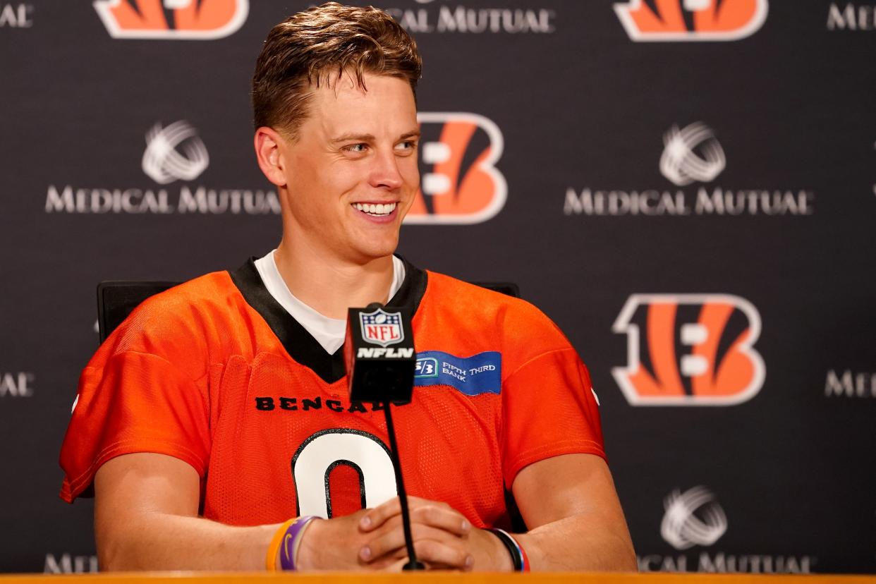 Cincinnati Bengals quarterback Joe Burrow (9) takes questions from reporters at the conclusion of organized team activities practice, Tuesday, June 14, 2022, at Paul Brown Stadium in Cincinnati.