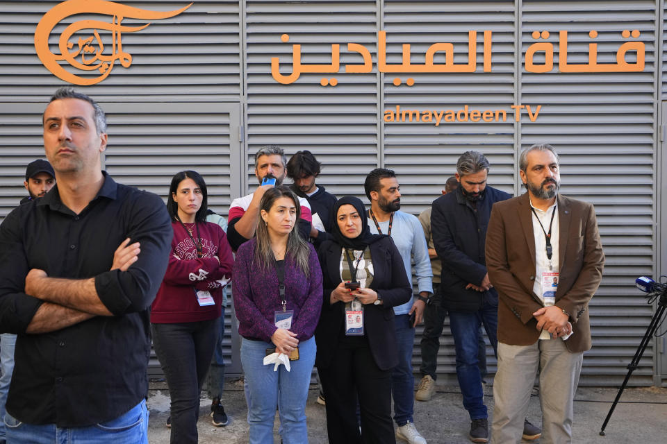 Journalists and family members of the two journalists of pan-Arab TV network Al-Mayadeen who were killed by an Israeli strike wait for the bodies outside the station's headquarters in Beirut, Lebanon, Tuesday, Nov. 21, 2023. An Israeli strike on southern Lebanon killed Tuesday two journalists reporting for the Beirut-based Al-Mayadeen TV on the violence along the border with Israel, according to the Lebanese information minister and their TV station. (AP Photo/Bilal Hussein)