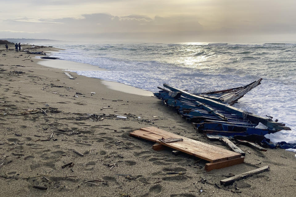 A view of part of the wreckage of a capsized boat that was washed ashore at a beach near Cutro, southern Italy, Monday, Feb. 27, 2023. Rescue crews searched by sea and air Monday for the dozens of people believed still missing from a shipwreck off Italy’s southern coast that drove home once again the desperate and dangerous crossings of migrants seeking to reach Europe. (AP Photo/Paolo Santalucia)