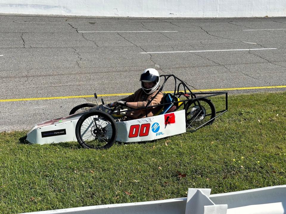 The No. 22 of Jack Strause sits on the apron at the enterance of Turn Three after suffering a broken left front wheel.