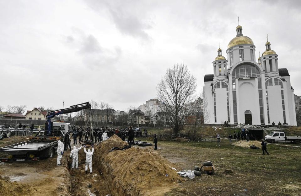 Ukrainian investigators exhume bodies from a mass grave in Bucha, Ukraine, in April 2022. <a href="https://media.gettyimages.com/id/1239836657/photo/topshot-ukraine-russia-conflict.jpg?s=1024x1024&w=gi&k=20&c=c4Da9Wl_2bWRs0_4eyieSucGBaSoBm6Ro27U82ZKtw8=" rel="nofollow noopener" target="_blank" data-ylk="slk:Genya Savilov/AFP via Getty Images;elm:context_link;itc:0;sec:content-canvas" class="link ">Genya Savilov/AFP via Getty Images</a>