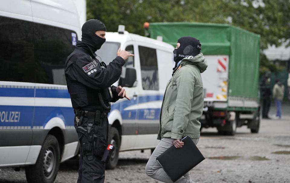 Police investigates in Duesseldorf, Germany, during raids in severals German cities, Wednesday, Oct. 6, 2021. German police have carried out large-scale raids in 25 cities in connection with a suspected money-laundering network alleged to have funneled more than $162 million in ill-gotten gains abroad. (AP Photo/Martin Meissner)