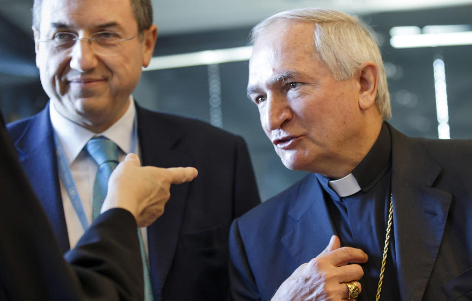 FILE - In this Monday, May 5, 2014, file photo, the Vatican's United Nations ambassador in Geneva, Archbishop Silvano M. Tomasi, right, speaks with others prior the U.N. torture committee hearing on the Vatican, at the headquarters of the office of the High Commissioner for Human Rights (OHCHR) in the Palais Wilson, in Geneva. Tomasi revealed comprehensive statistics for the first time Tuesday on how the Vatican has disciplined priests accused of raping and molesting children, saying 848 priests have been defrocked and another 2,572 given lesser sanctions over the past decade. (AP Photo/Keystone, Salvatore Di Nolfi, File)