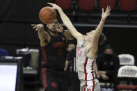 San Diego State's Matt Mitchell (11) passes the ball against UNLV's Moses Wood (1) during the second half of an NCAA college basketball game Wednesday, March 3, 2021, in Las Vegas. (AP Photo/Joe Buglewicz)