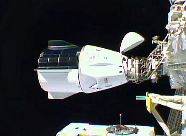 The SpaceX Crew Dragon capsule, with its protective nose cap hinged up and out of the way, moments after docking late on November 16, 2020 at the International Space Station's forward port, the same port once used by visiting space shuttles.  / Credit: NASA