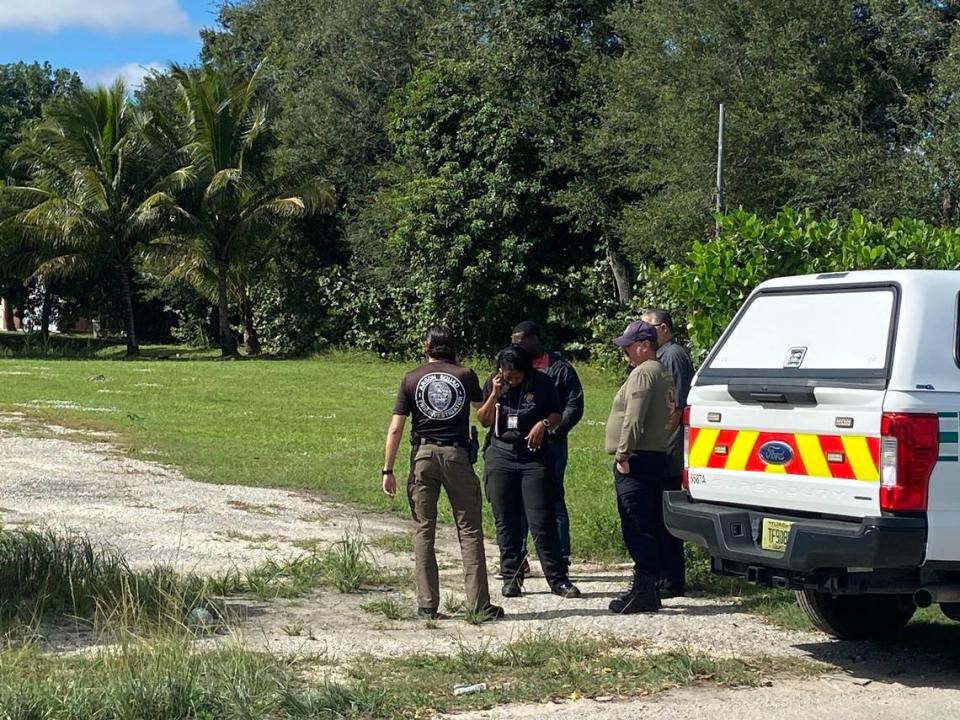 Detectives with the Miami-Dade County Police Department’s Arson Squad stand in front of a home in the Redland agricultural area in southwest Miami-Dade County Monday, Nov. 27, 2023. A man has barricaded himself inside the home.