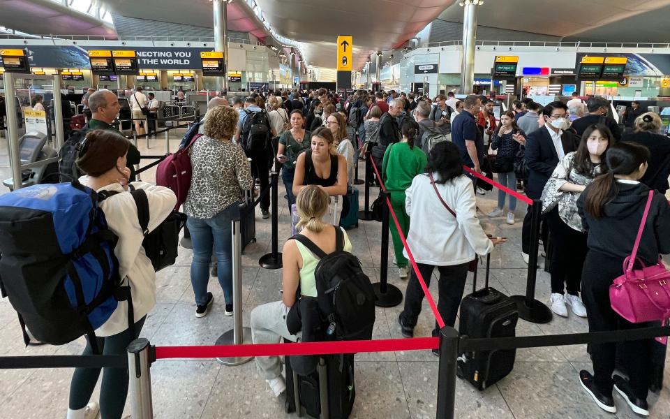 Travellers queue at security at Heathrow Airport in London during the travel chaos of June 2022 - AP Photo/Frank Augstein