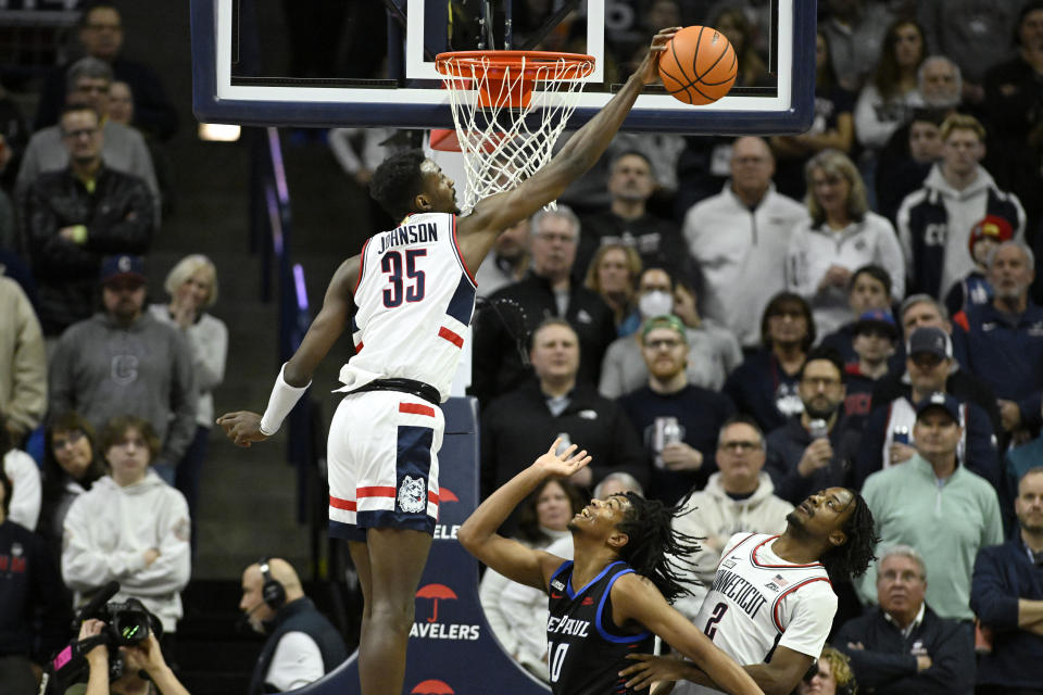 UConn forward Samson Johnson (35) blocks a shot by DePaul guard Jaden Henley (10) in the first half of an NCAA college basketball game, Tuesday, Jan. 2, 2024, in Storrs, Conn. (AP Photo/Jessica Hill)