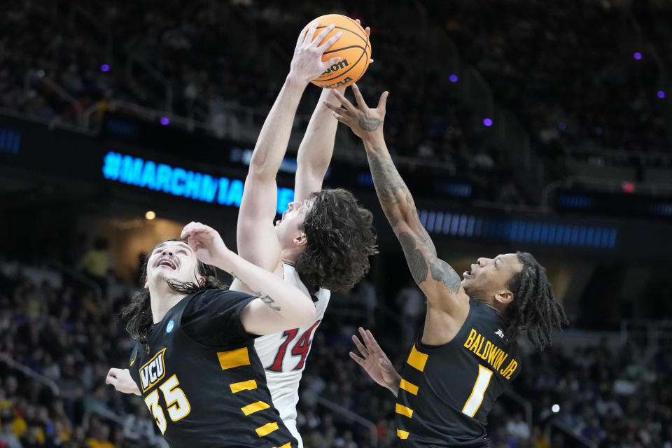 St. Mary's Kyle Bowen (14) rebounds against Virginia Commonwealth's Adrian Baldwin Jr. (1) and David Shriver (35) in the second half of a first-round college basketball game in the NCAA Tournament, Friday, March 17, 2023, in Albany, N.Y. (AP Photo/John Minchillo)