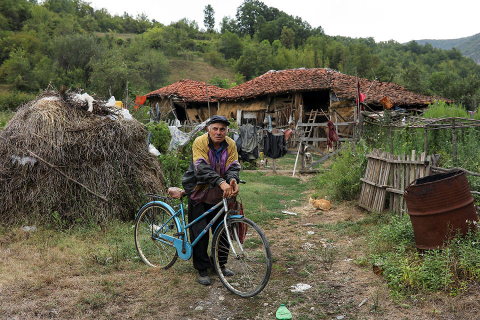 <p>A man holds his bicycle in front of his home in the village of Gornja Kamenica, near the southeastern town of Knjazevac, Serbia, Aug. 14, 2017. (Photo: Marko Djurica/Reuters) </p>