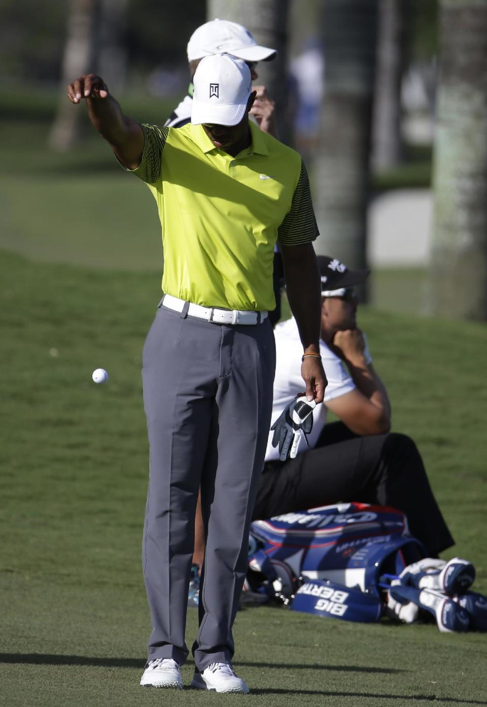 Tiger Woods takes a drop on the eighth hole during the second round of the Cadillac Championship golf tournament Friday, March 7, 2014, in Doral, Fla. More than 100 balls went into the water in the newly designed course. (AP Photo/Lynne Sladky)