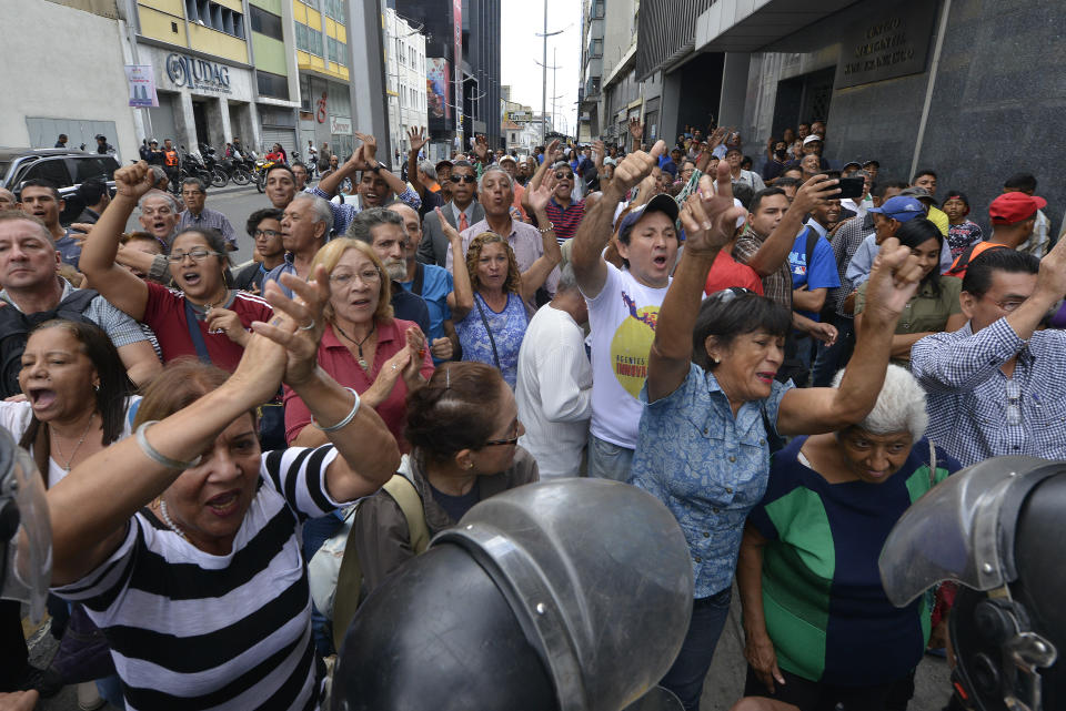 Supporters of opposition leader Juan Guaido cheer for him as he leaves the National Assembly where he was sworn-in as president of the legislature in Caracas, Venezuela, Tuesday, Jan. 7, 2020. Guaidó and opposition lawmakers pushed their way into Venezuela's legislative building Tuesday following a standoff with security forces as the nation's political divide deepens. (AP Photo/Matias Delacroix)