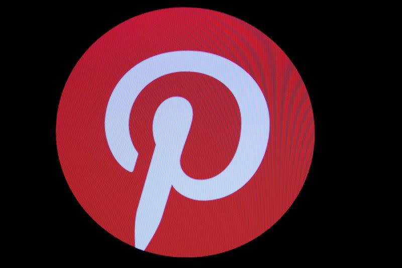 FILE PHOTO: Screens display the company logo for Pinterest Inc. during the company's IPO on the front of the NYSE in New York