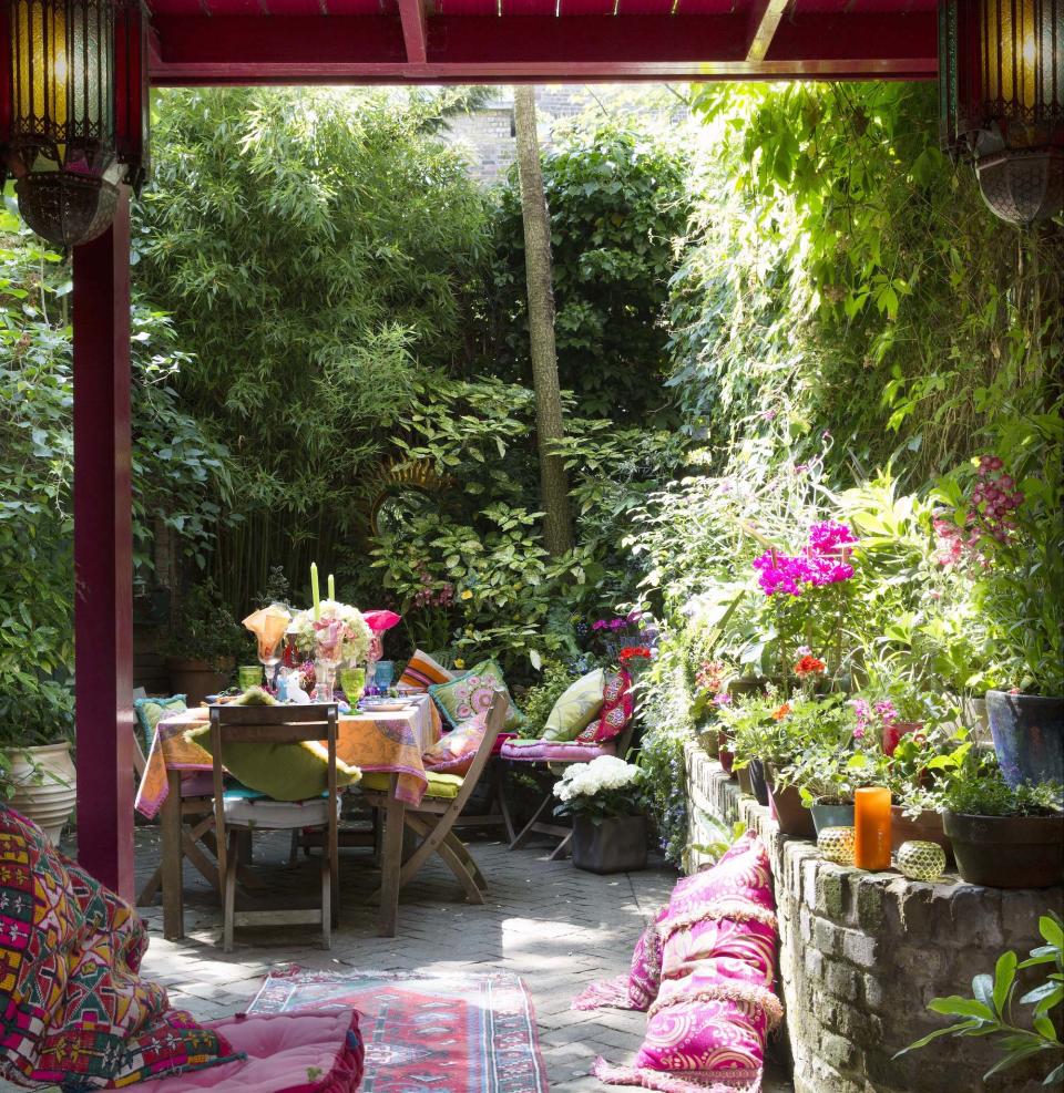 garden with plants trees and table chair