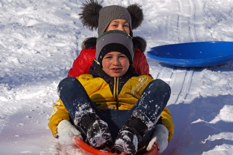 People play in the snow that fell during a Nor'easter storm in New York