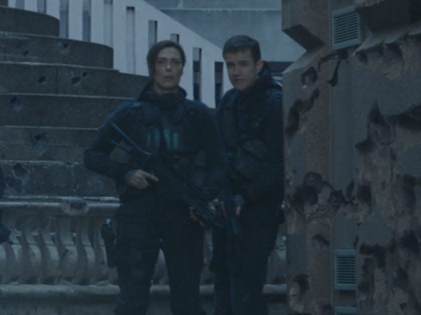 katniss' rebel army posed in front of a courtyard in hunger games mockingjay part 2