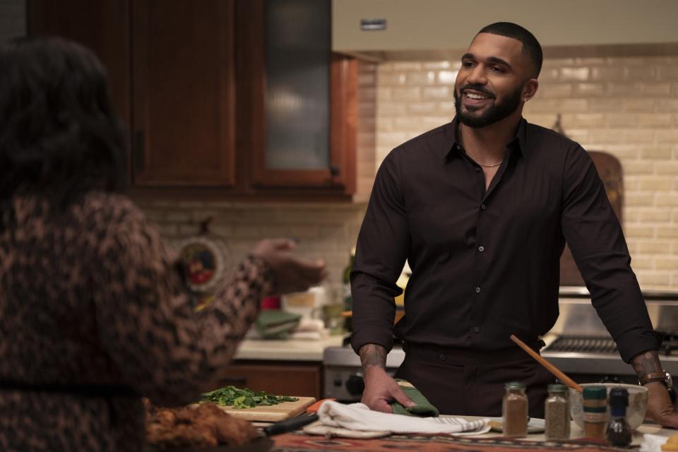 Tyler Lepley leaning on the kitchen island on "Harlem"