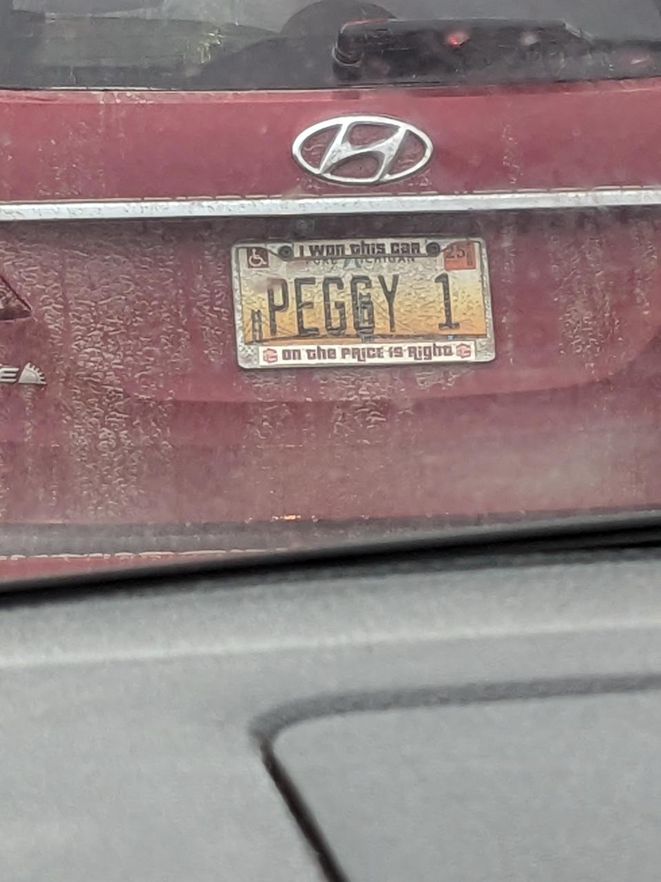 License plate reads "PEGGY 1" with a frame stating "I won this car on The Price is Right." Vehicle appears dusty