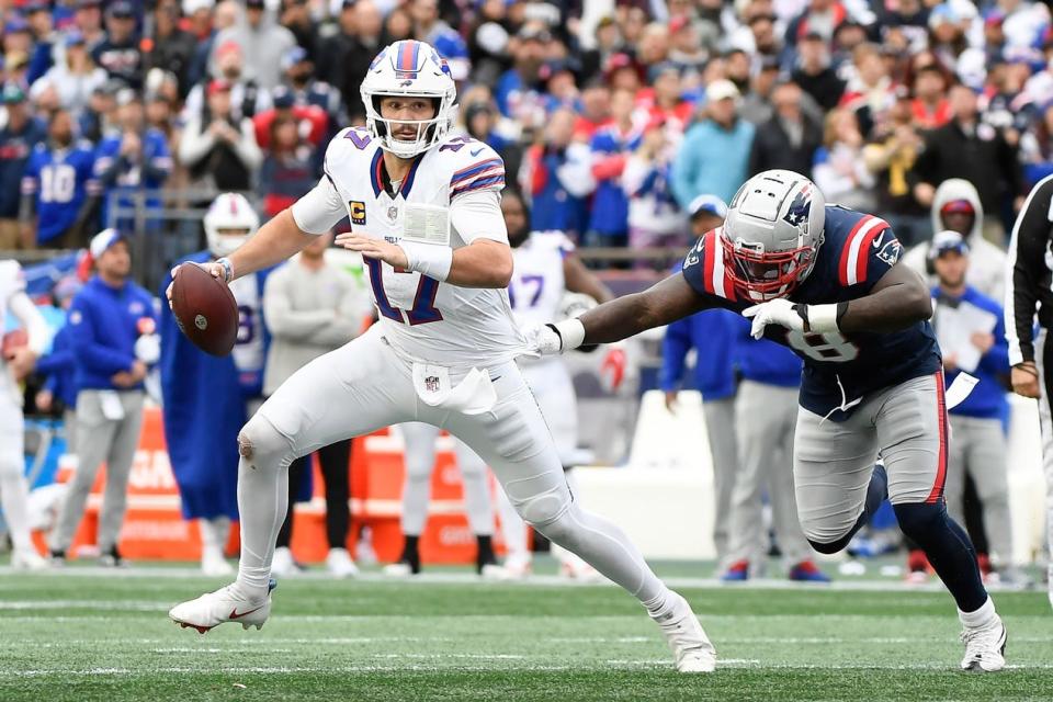 Oct 22, 2023; Foxborough, Massachusetts, USA; Buffalo Bills quarterback Josh Allen (17) scrambles away from New England Patriots linebacker Ja'Whaun Bentley (8) during the second half at Gillette Stadium. Mandatory Credit: Bob DeChiara-USA TODAY Sports