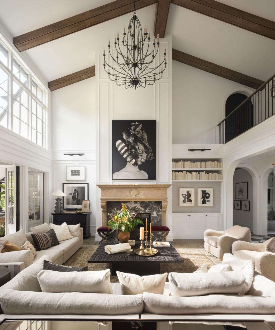 open plan living room with stone fireplace and white furniture