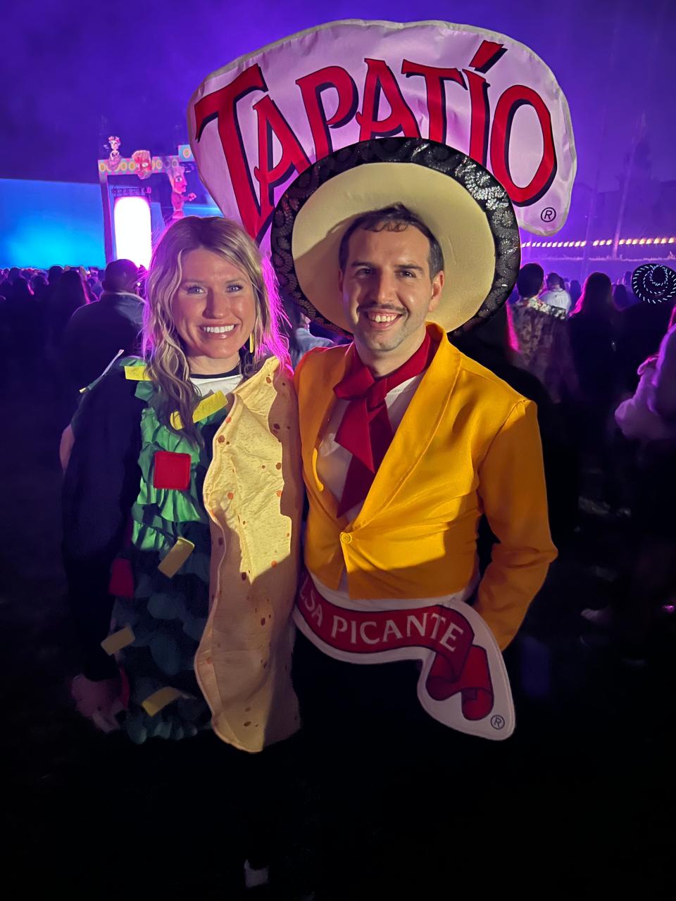 A couple dresses up as the Tapatio Hot Sauce and a taco at the Día de Los Muertos celebration at the Hollywood Forever Cemetery in Los Angeles on Saturday, Oct. 28, 2023.