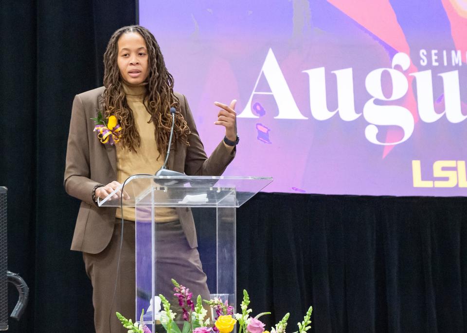 Basketball star Seimone Augustus speaks during a ceremony to unveil her statue on LSU's campus on Sunday.