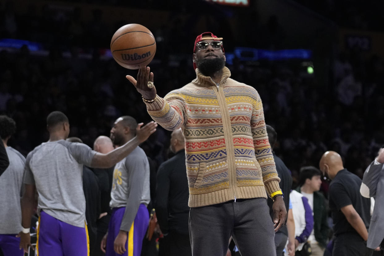 Los Angeles Lakers forward LeBron James holds a basketball during a timeout during the second half of an NBA basketball game against the New York Knicks Sunday, March 12, 2023, in Los Angeles. (AP Photo/Marcio Jose Sanchez)