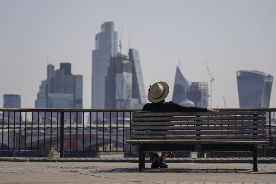 A man sits on a bench on the south bank of river Thames, in London, Monday, July 18, 2022. Britain’s first-ever extreme heat warning is in effect for large parts of England as hot, dry weather that has scorched mainland Europe for the past week moves north, disrupting travel, health care and schools. (AP Photo/Alberto Pezzali)