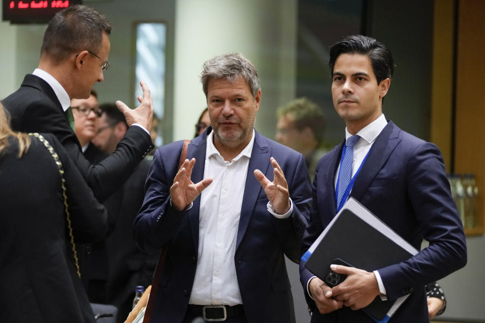 Germany Climate Action Minister Robert Habeck, center, speaks with Hungary's Foreign Minister Peter Szijjarto, left, and Netherland's Climate and Energy Minister Rob Jetten during a meeting of EU energy ministers in Brussels on Friday, Sept. 30, 2022. European Union energy ministers were set Friday to adopt a package of measures including a windfall levy on profits by fossil fuel companies, but a deal on capping gas prices remained off the table. (AP Photo/Virginia Mayo)