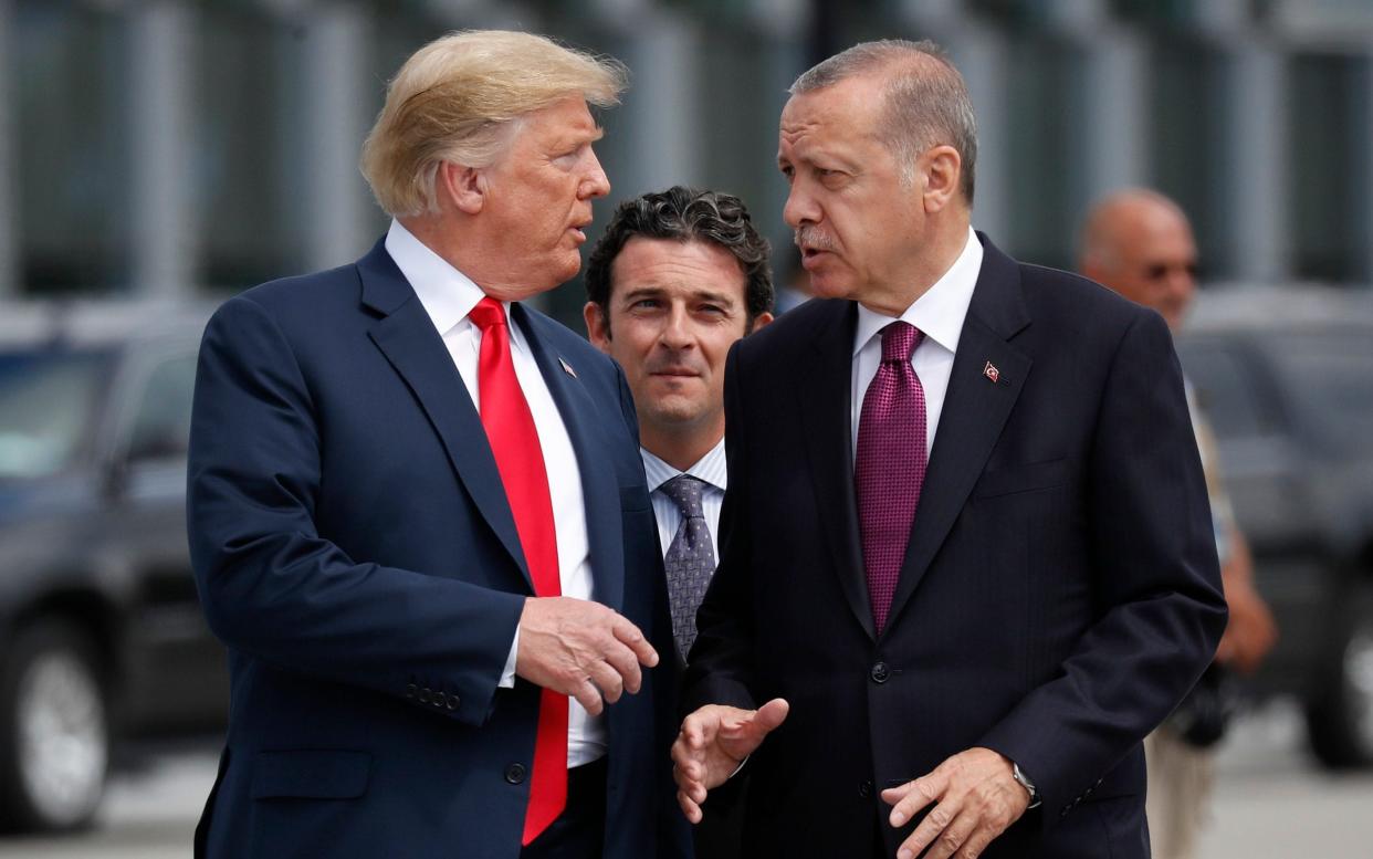 President Donald Trump, left, talks with Turkey's President Recep Tayyip Erdogan, as they arrive together for a summit of heads of state and government at NATO headquarters in Brussels - AP