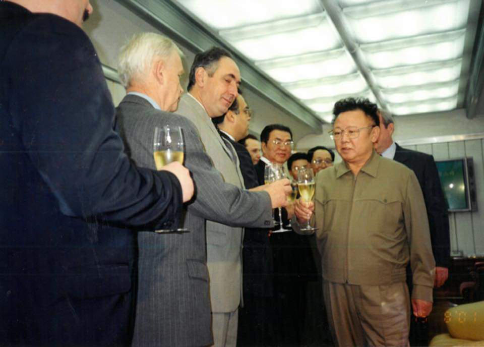 In this photo taken Aug. 15, 2001, North Korean leader Kim Jong Il, right, toasts with North Korean and Russian officials inside a train somewhere in Russia. North Korean leader Kim Jong Un, like his father Kim Jong Il, is likely to travel by train to Vladivostok in Russia for a much-anticipated summit with Russian President Vladimir Putin on upcoming Thursday, a Kremlin adviser said, putting an end to weeks of speculation about when and where it would take place. (Georgy Toloraya via AP)