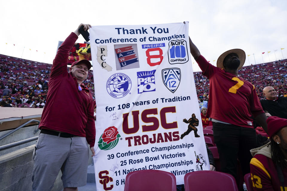 Fans hold up a sign during the second half of an NCAA college football game between Southern California and UCLA, Saturday, Nov. 18, 2023, in Los Angeles. (AP Photo/Ryan Sun)