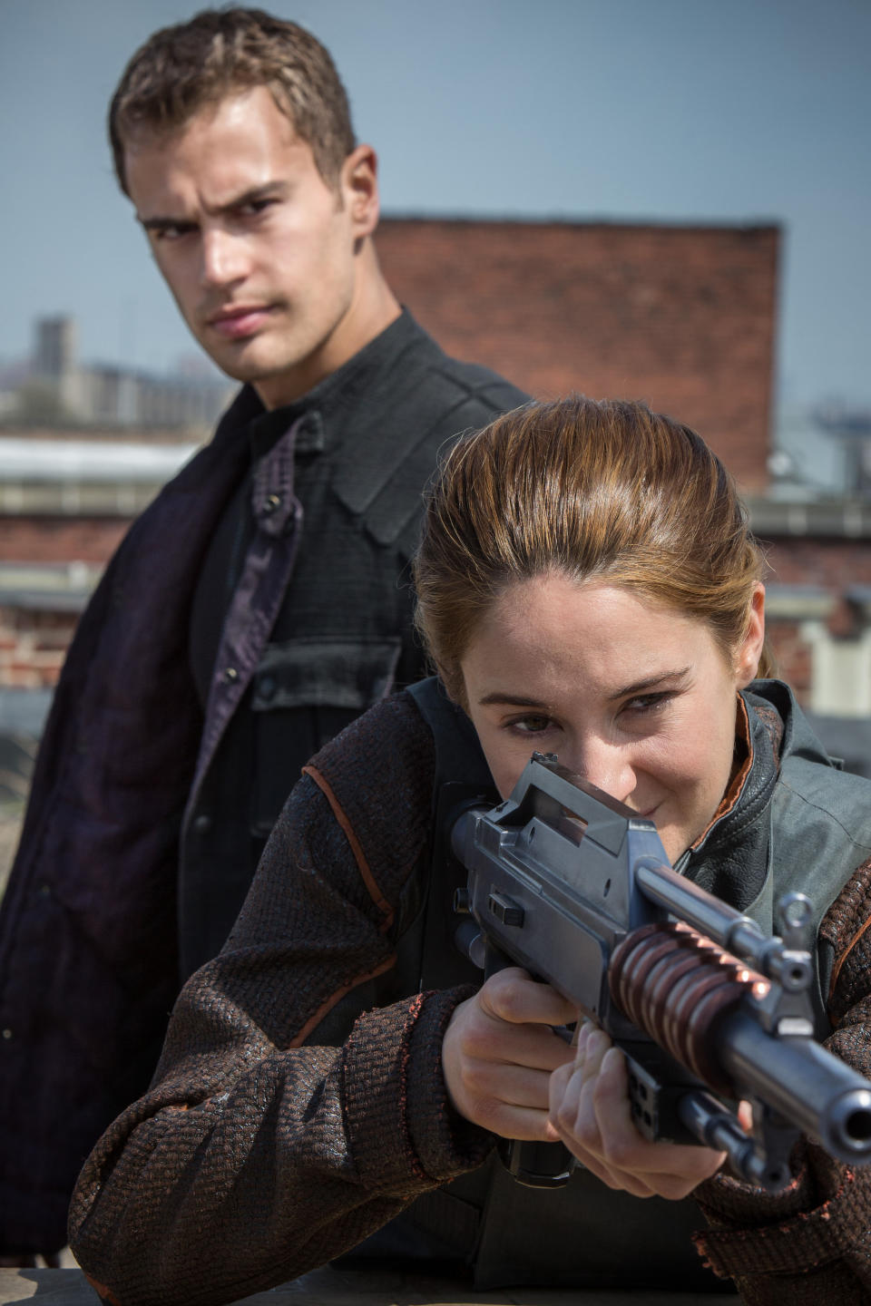 This photo released by Summit Entertainment, LLC shows Theo James as Four, rear, and Shailene Woodley as Beatrice "Tris" Prior, right, in the film, "Divergent." The movie releases on Friday, March 21, 2014. (AP Photo/Summit Entertainment, Jaap Buitendijk)