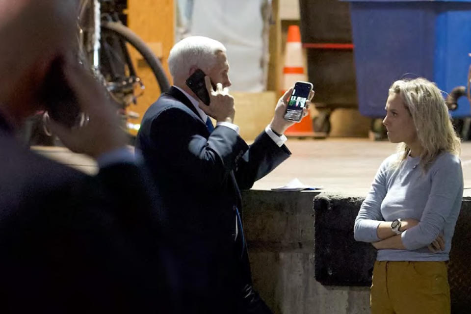 In this image released in the final report by the House select committee investigating the Jan. 6 attack on the U.S. Capitol, on Thursday, Dec. 22, 2022, Vice President Mike Pence talks on the phone from a secured loading dock at the U.S. Capitol as he looks at another phone with a recording of video statement President Donald Trump on Jan. 6, 2021. (House Select Committee via AP)
