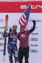 Third place United States' Travis Ganong is flanked by ski legend Daron Rahlves on the podium after an alpine ski, men's World Cup downhill race in Kitzbuehel, Austria, Saturday, Jan. 21, 2023. (AP Photo/Giovanni Auletta)