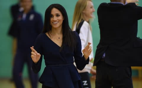 Meghan, Duchess of Sussex, roots for her team - Credit: Eddie Mulholland For The Telegraph