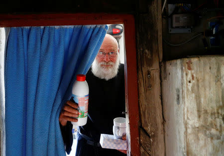 Hermit Stan Vanuytrecht of Belgium prepares coffee in the hermitage in Saalfelden, Austria, May 22, 2017. Picture taken May 22, 2017. REUTERS/Leonhard Foeger