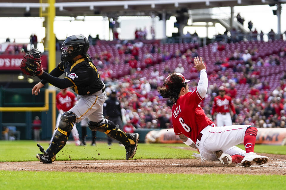 Cincinnati Reds' Jonathan India (6) scores on a Tyler Stephenson single against Pittsburgh Pirates catcher Austin Hedges in the third inning of a baseball game in Cincinnati, Sunday, April 2, 2023. (AP Photo/Jeff Dean)