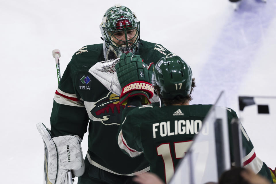 Minnesota Wild goaltender Marc-Andre Fleury (29) celebrates with left wing Marcus Foligno (17) after defeating the New York Islanders in an NHL hockey game Monday, Jan. 15, 2024, in St. Paul, Minn. (AP Photo/Stacy Bengs)