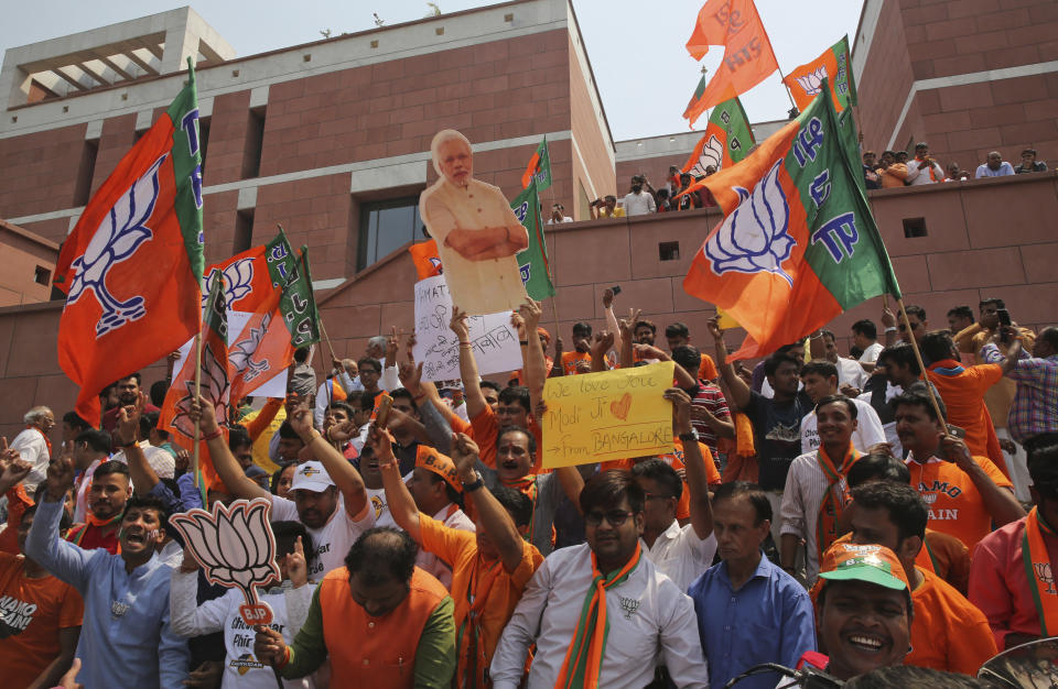 Bharatiya Janata Party (BJP) supporters celebrate their party's victory in the general elections in New Delhi, India, Thursday, May 23, 2019. Indian Prime Minister Narendra Modi's party claimed it had won reelection with a commanding lead in Thursday's vote count, while the stock market soared in anticipation of another five-year term for the pro-business Hindu nationalist leader. (AP Photo/Manish Swarup)