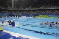 <p>Members of the United States team swim in water as they celebrate their victory during women’s gold medal water polo match against Italy at the 2016 Summer Olympics in Rio de Janeiro, Brazil, Friday, Aug. 19, 2016. (AP Photo/Sergei Grits) </p>