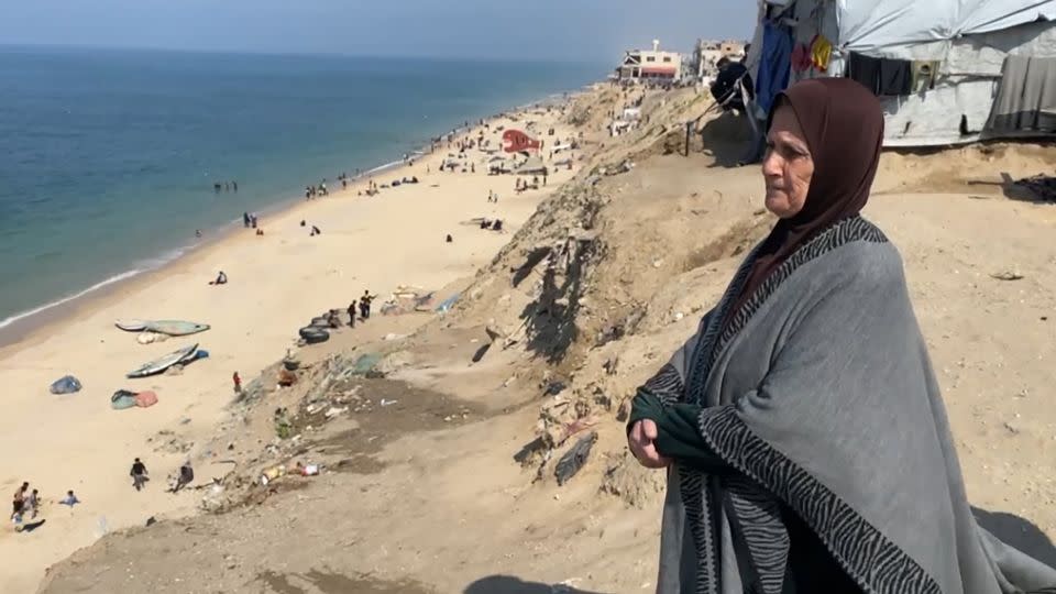 Um Ihab stands by the beach along the coast of central Gaza. - CNN