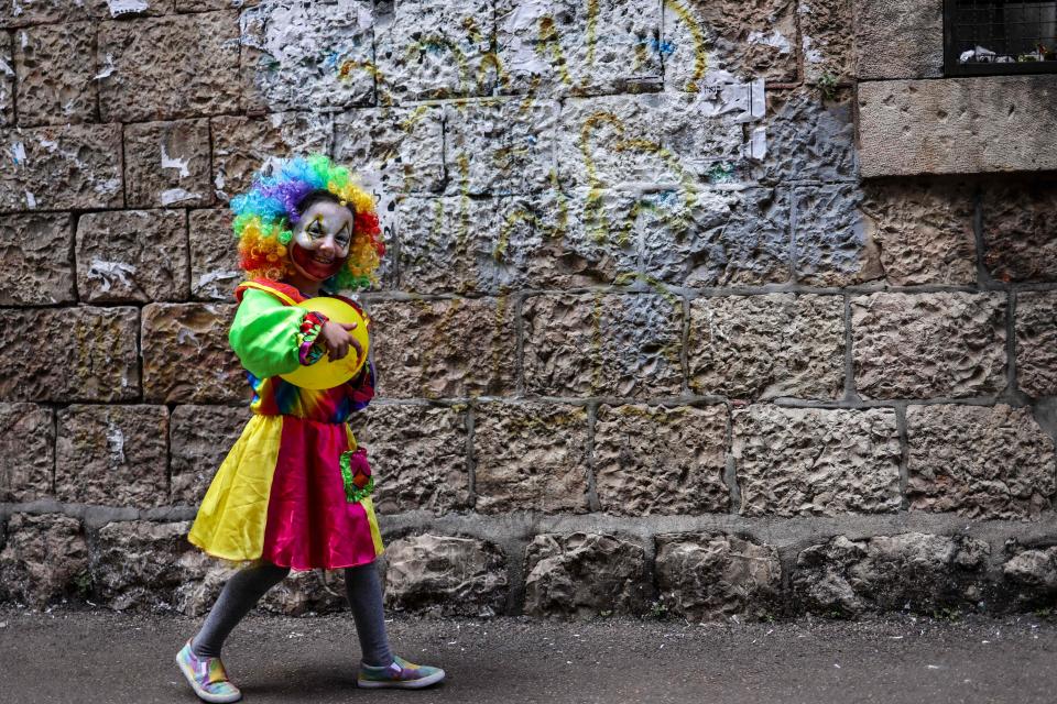 A child dressed in a costume celebrates Purim in the Mea Shearim ultra-Orthodox neighborhood in Jerusalem in 2023.