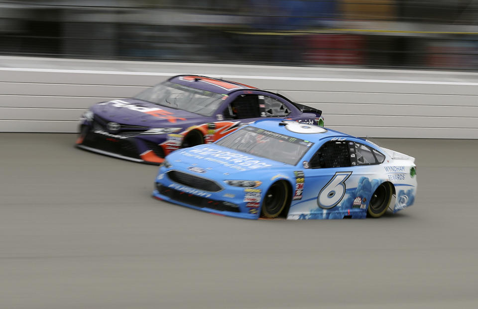 Denny Hamlin, left, and Matt Kenseth, right, race during the NASCAR Cup Series auto race, Sunday, June 10, 2018, in Brooklyn, Mich. (AP Photo/Carlos Osorio)