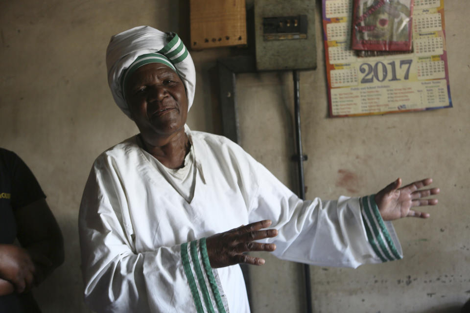 72-year old grandmother Esther Zinyoro Gwena is seen in her a tiny apartment in the poor surburb of Mbare in Harare, Zimbabwe, Saturday, Nov. 16, 2019. Grandmother Esther Zinyoro Gwena claims to be guided by the holy spirit and has become a local hero, as the country’s economic crisis forces closure of medical facilities, and mothers-to-be seek out untrained birth attendants.(AP Photo/Tsvangirayi Mukwazhi)