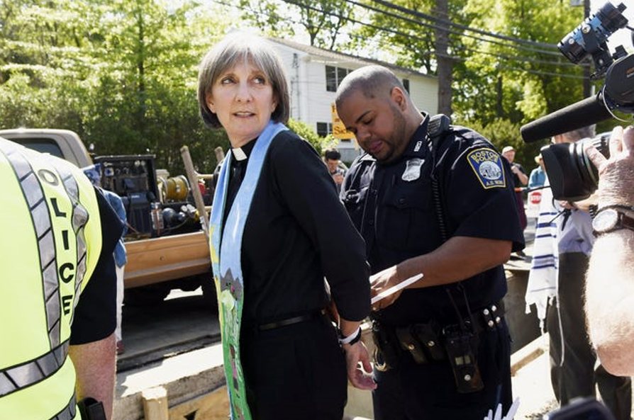 Anne Bancroft of the Theodore Parker Unitarian Church in West Roxbury is arrested along with 15 other local religious leaders as they blocked the construction of the West Roxbury Lateral pipeline on Grove Street, May 25, 2016.